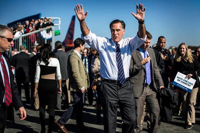 Republican presidential candidate Mitt Romney returns to the campaign plane after a campaign rally in Lynchburg, Virginia. He was also campaigning in Florida, Ohio and New Hampshire on the eve of the election.