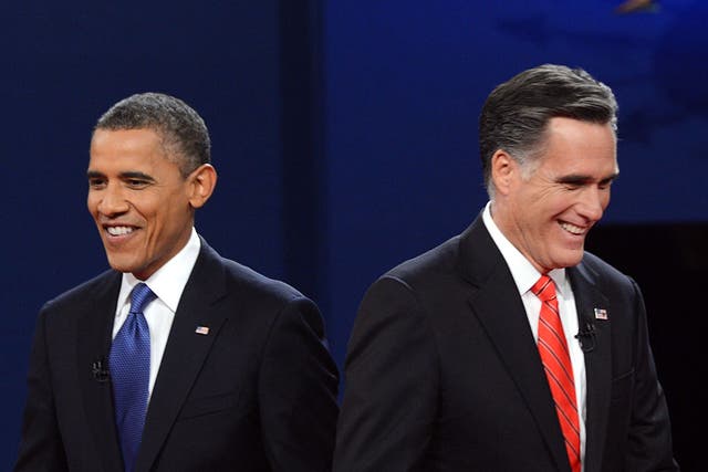 US President Barack Obama (L) and Republican presidential candidate Mitt Romney finish their debate at the University of Denver in Denver, Colorado, October 3, 2012.
