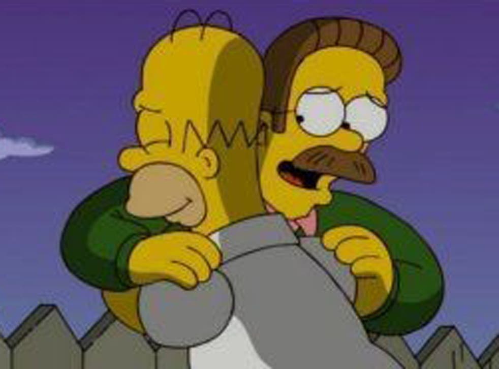 Homer and Ned Flanders share a neighbourly embrace across the garden fence