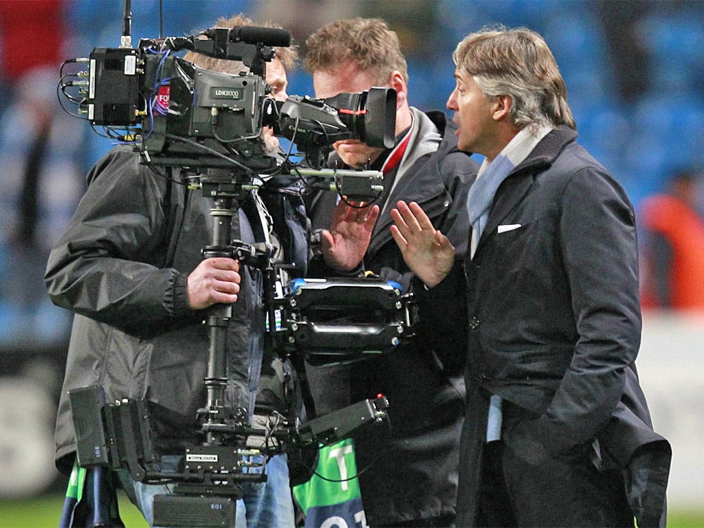 Roberto Mancini confronts a cameraman after the game