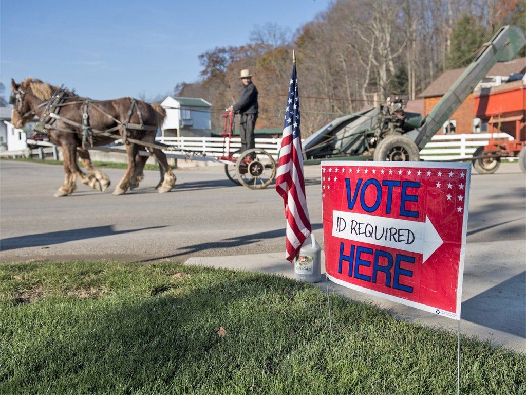 A farmer passes a polling station during election day in Becks Mill, Ohio