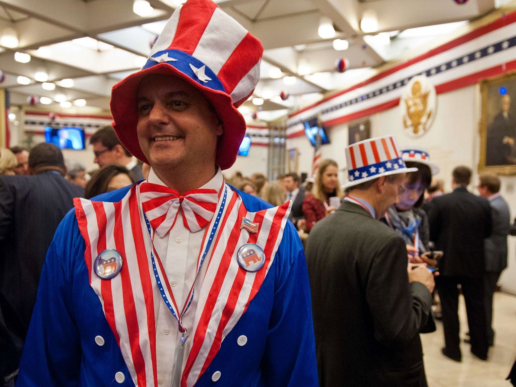 A reveller awaits results at the US Embassy in London during the traditional election night party