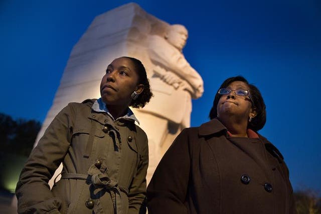 Arien Parham, 29, left, a paralegal who lives in Washington, and her mother, Vanessa Cayton, a social worker from Chandler, Ariz., visit the Martin Luther King Memorial the day before the election. President Barack Obama's re-election has provided what many blacks say will surely deepen his legacy: irrefutable evidence that his presidency is hardly a historical fluke.