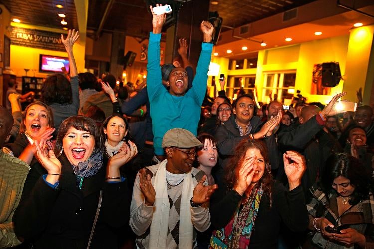 Supporters of President Obama who gathered at the Busboys and Poets restaurant in Washington erupt in cheers as Obama is projected to win the presidential election on Tuesday.