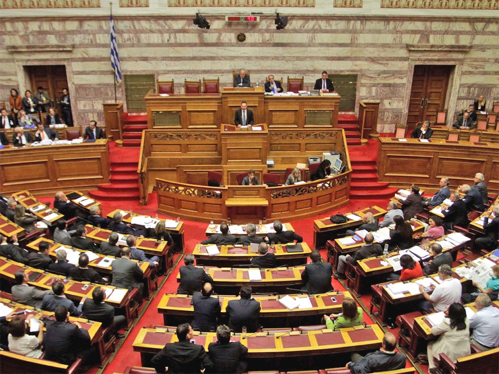 Finance Minister Yannis Stournaras speaks during a session of the Greek parliament in Athens today