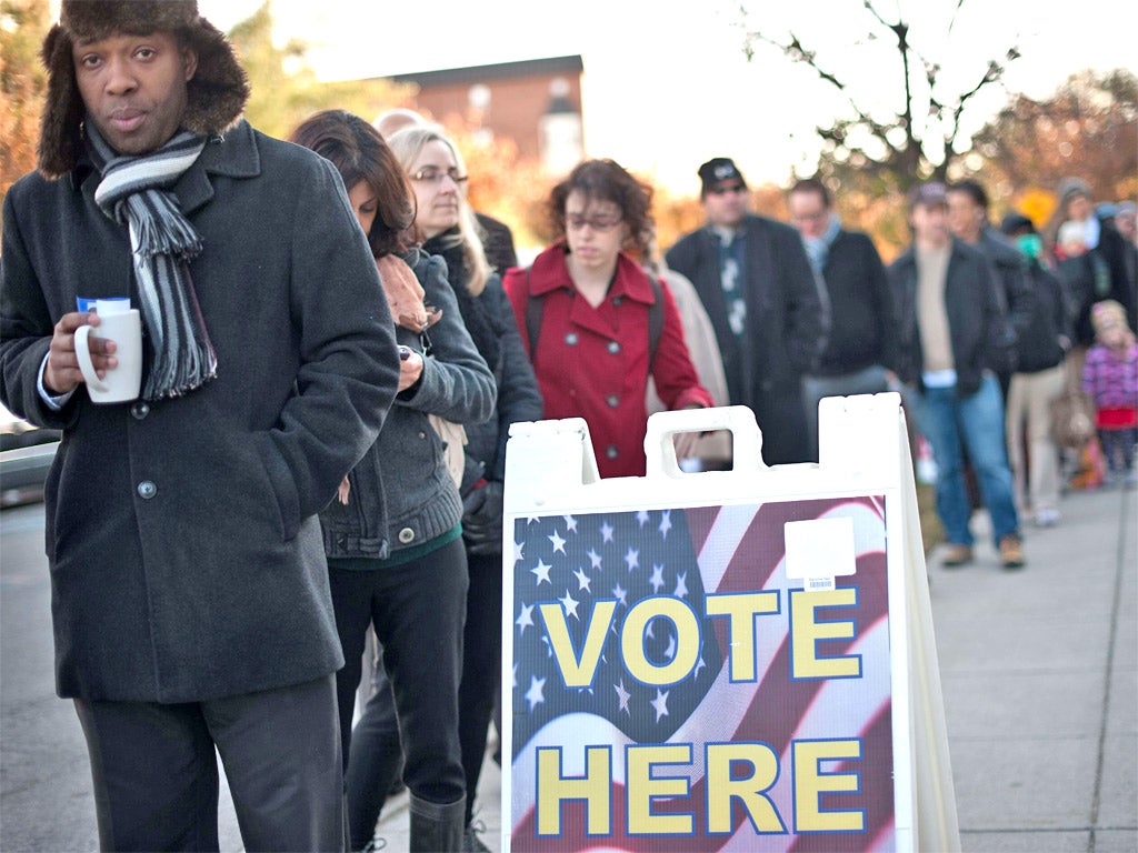 Voters queue to cast their ballots at a polling station in Washington,DC