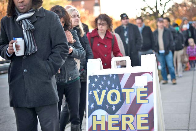 Voters queue to cast their ballots at a polling station in Washington,DC