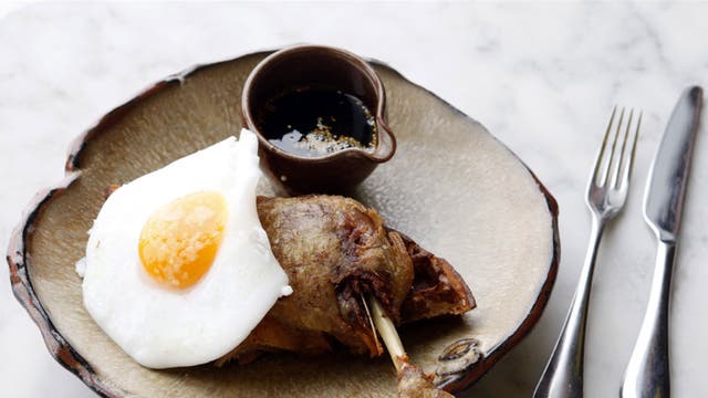 The dish making foodies go quackers: duck leg with waffles, egg and maple syrup, prepared by Tom Cenci