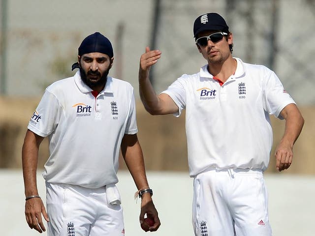 England captain Alastair Cook (right) speaks with bowler Monty Panesar