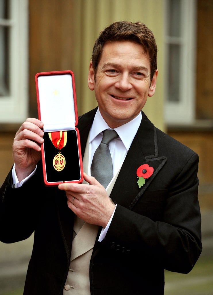 Actor Sir Kenneth Branagh poses with his award after receiving a knighthood from Queen Elizabeth II at an investiture ceremony at Buckingham Palace on November 9, 2012 in London, England.