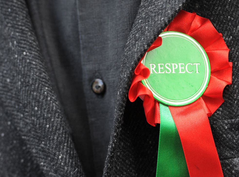 British politician George Galloway wears a rosette of his Respect party as he speaks to the media in Bradford, northern England, on March 30, 2012