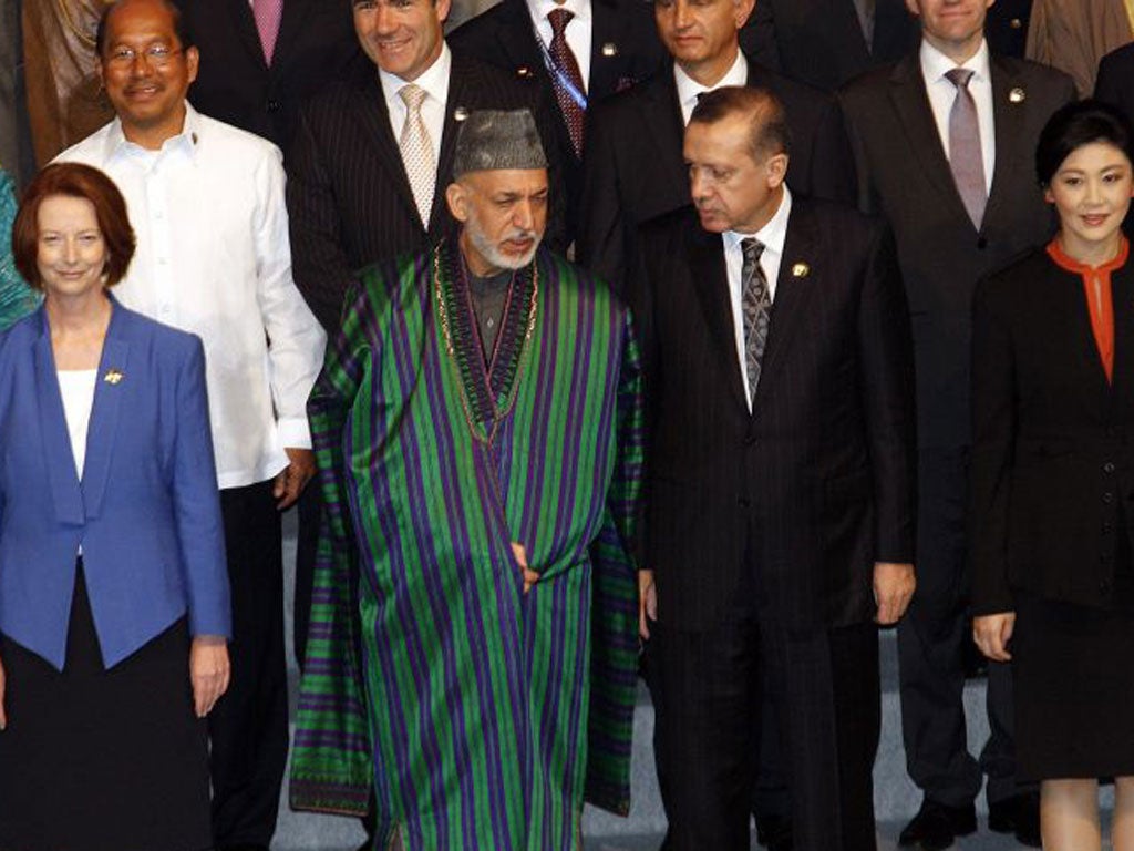 From left: Julia Gillard, Hamid Karzai, Recep Erdogan and Yingluck Shinawatra in Bali. Below, Mahmoud Ahmadinejad