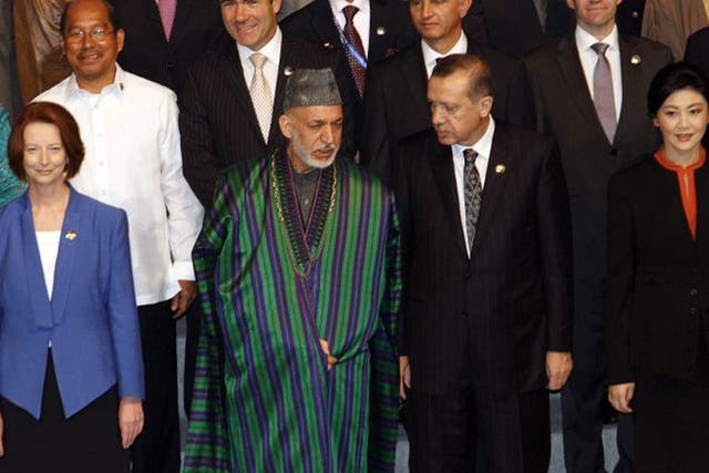 From left: Julia Gillard, Hamid Karzai, Recep Erdogan and Yingluck Shinawatra in Bali. Below,  Mahmoud Ahmadinejad