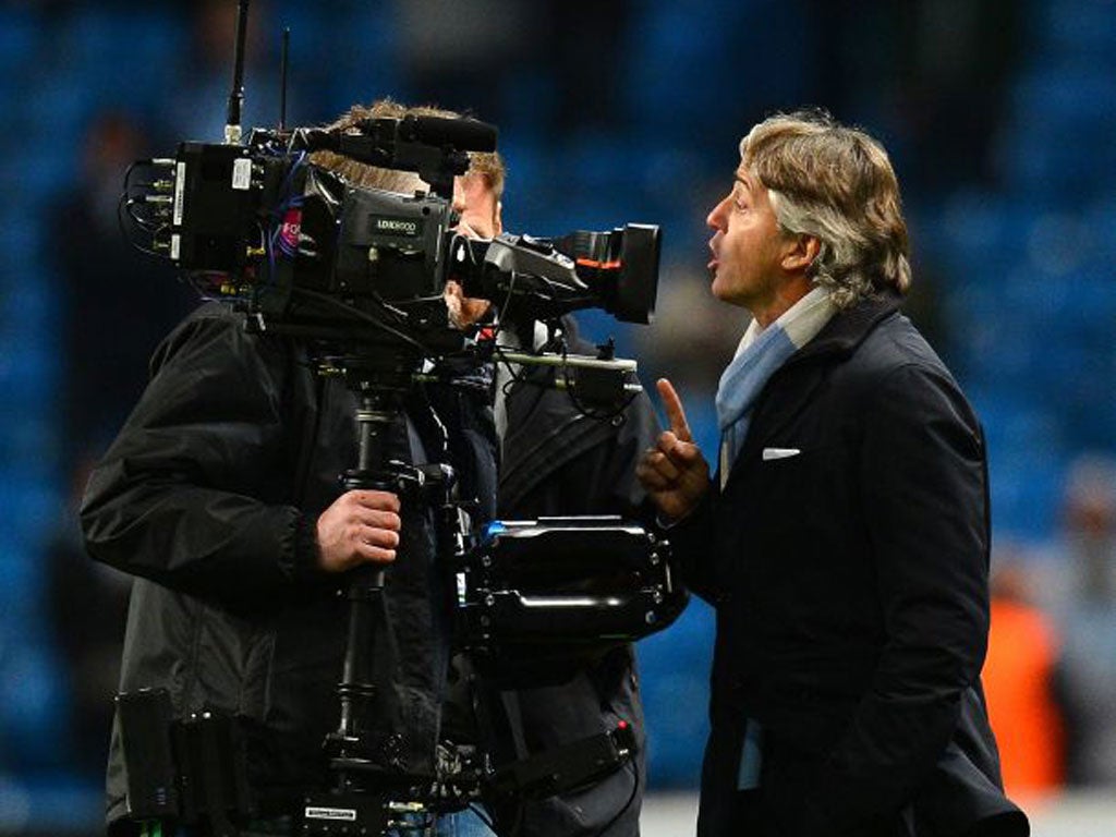 Roberto Mancini confronts a TV cameraman on Tuesday