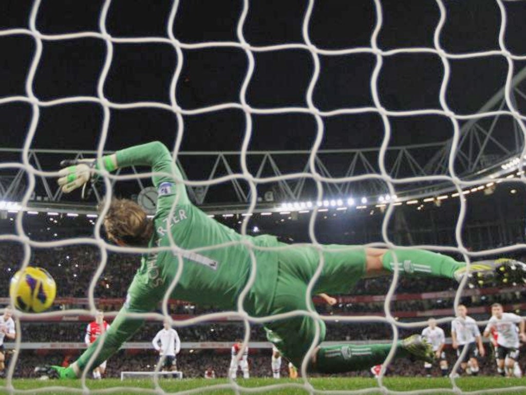 Fulham's Australian goalkeeper Mark Schwarzer saves the penalty taken by Arsenal's Spanish player Mikel Arteta