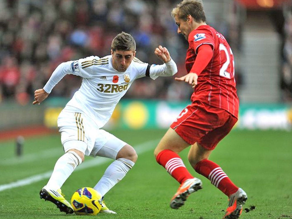 Luke Shaw of Southampton and Pablo Hernandez of Swansea City in action