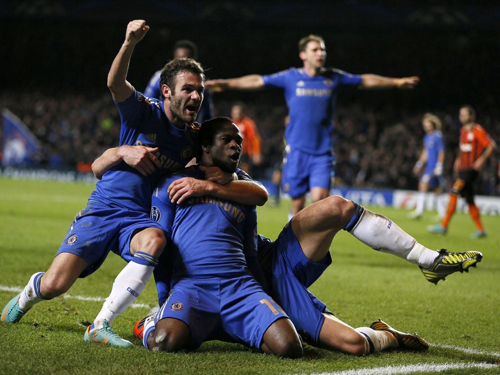 Holy moses: Juan Mata, left, joins the celebrations with winning goalscorer Victor Moses against Shakhtar