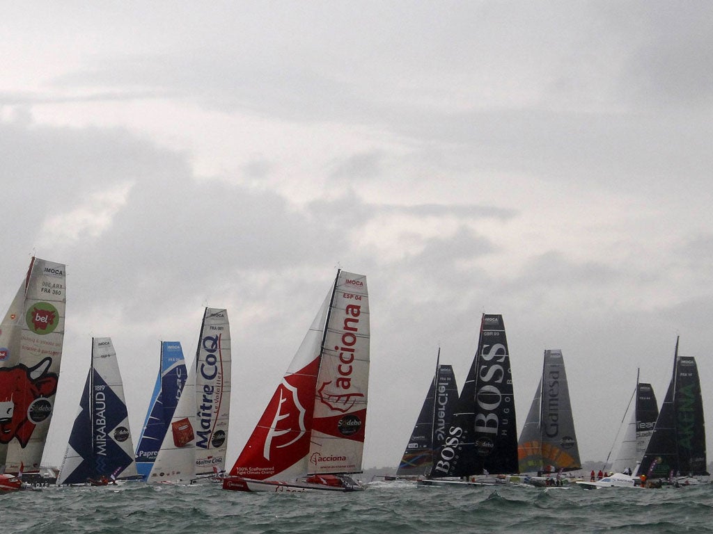 Queuing for the sails: The fleet leaves, with Alex Thomson unfurling the Boss livery