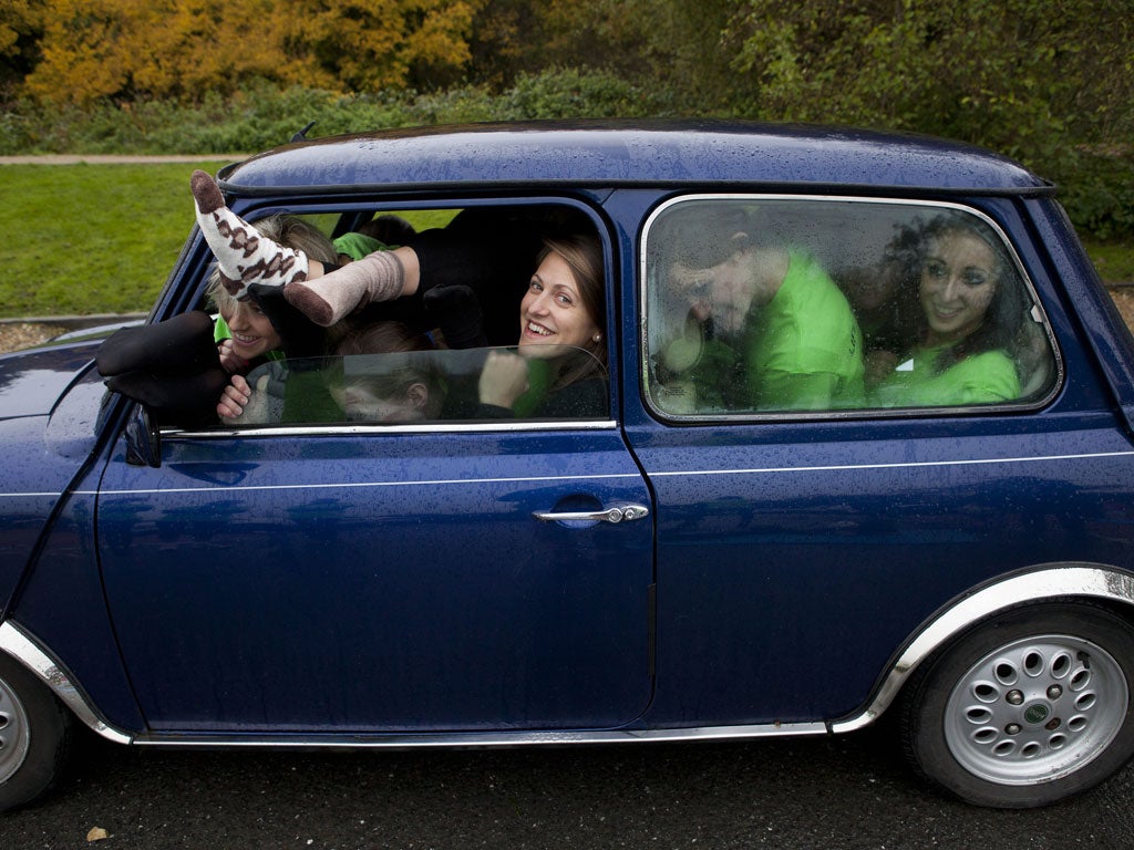 Tight fit: Emily Dugan, in front seat, joins the group in a rehearsal for the world record attempt in the original Mini