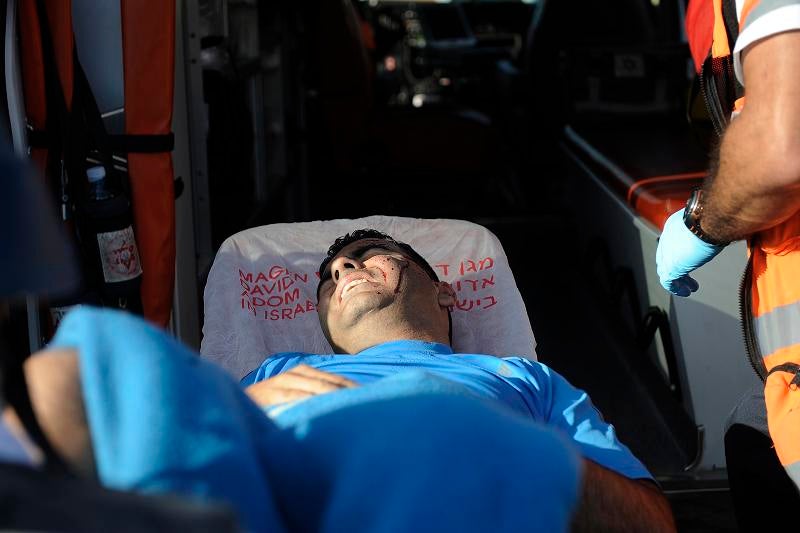 An Israeli man reacts as he receives treatment after he was injured by a rocket launched from the Palestinian Gaza Strip towards the southern Israeli city of Sderot on November 11