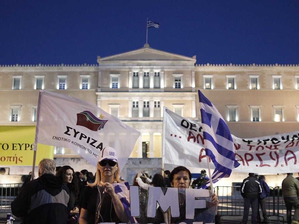 Protesters gathered outside parliament in Athens last night