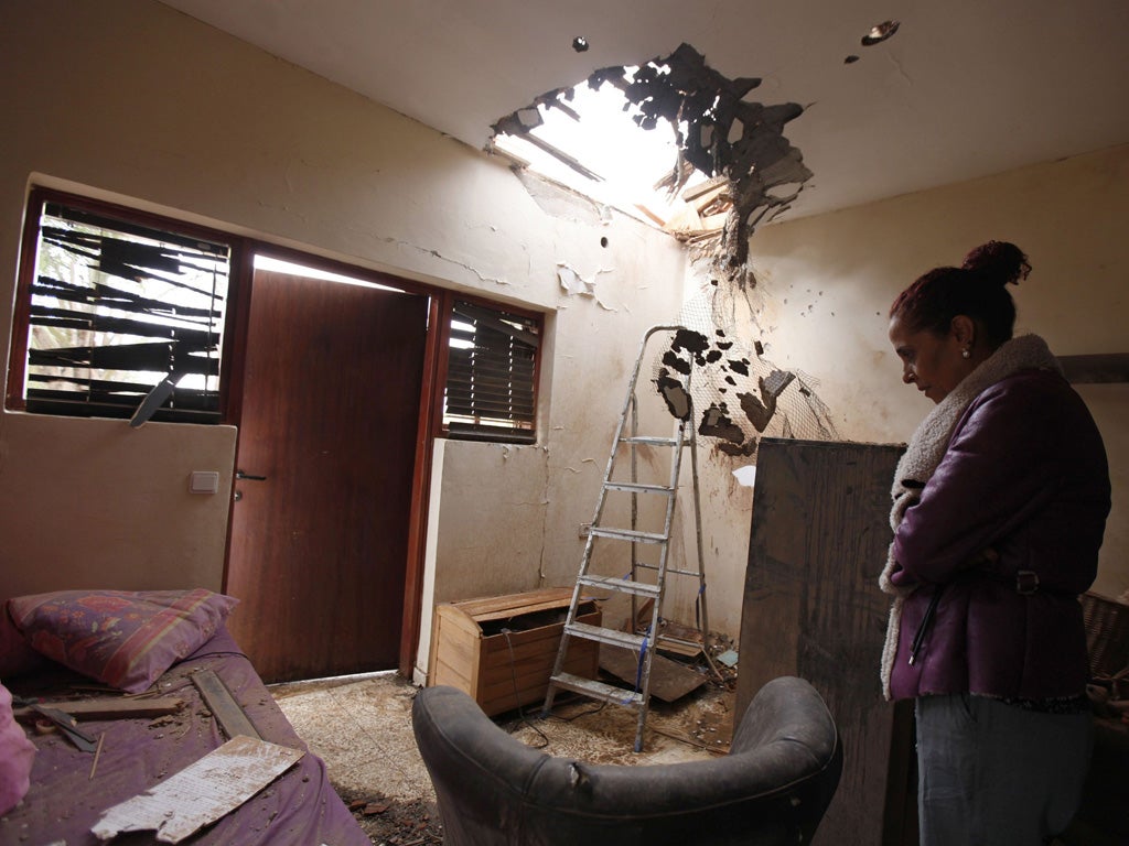 Tami Shadadi surveys the damage to her house in the southern town of Sderot