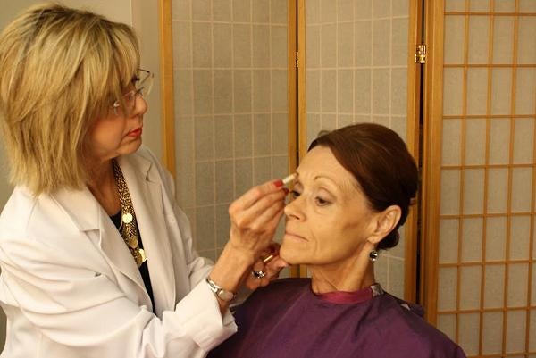 CANCER BEAUTY: Marianne Kelly, founder of the Image Recovery Center, a beauty salon at John's Hopkins Hospital in Baltimore, Maryland, draws an eyebrow on Margaret Fisher's face. Many hospitals offer beauty salon services that boost patients self-esteem.