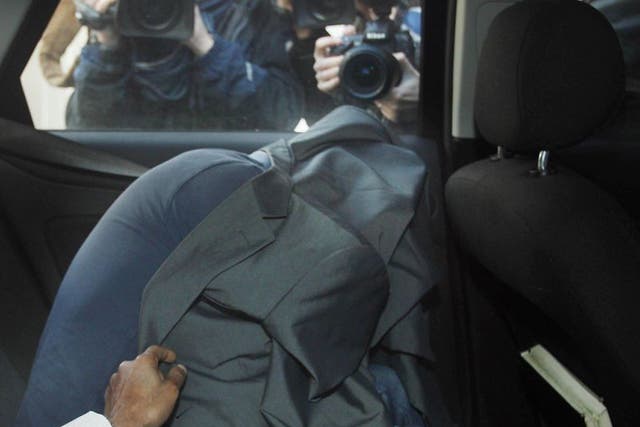 A March 2012 photograph of Edward Devenney covering himself up as he arrives at Westminster Magistrates Court