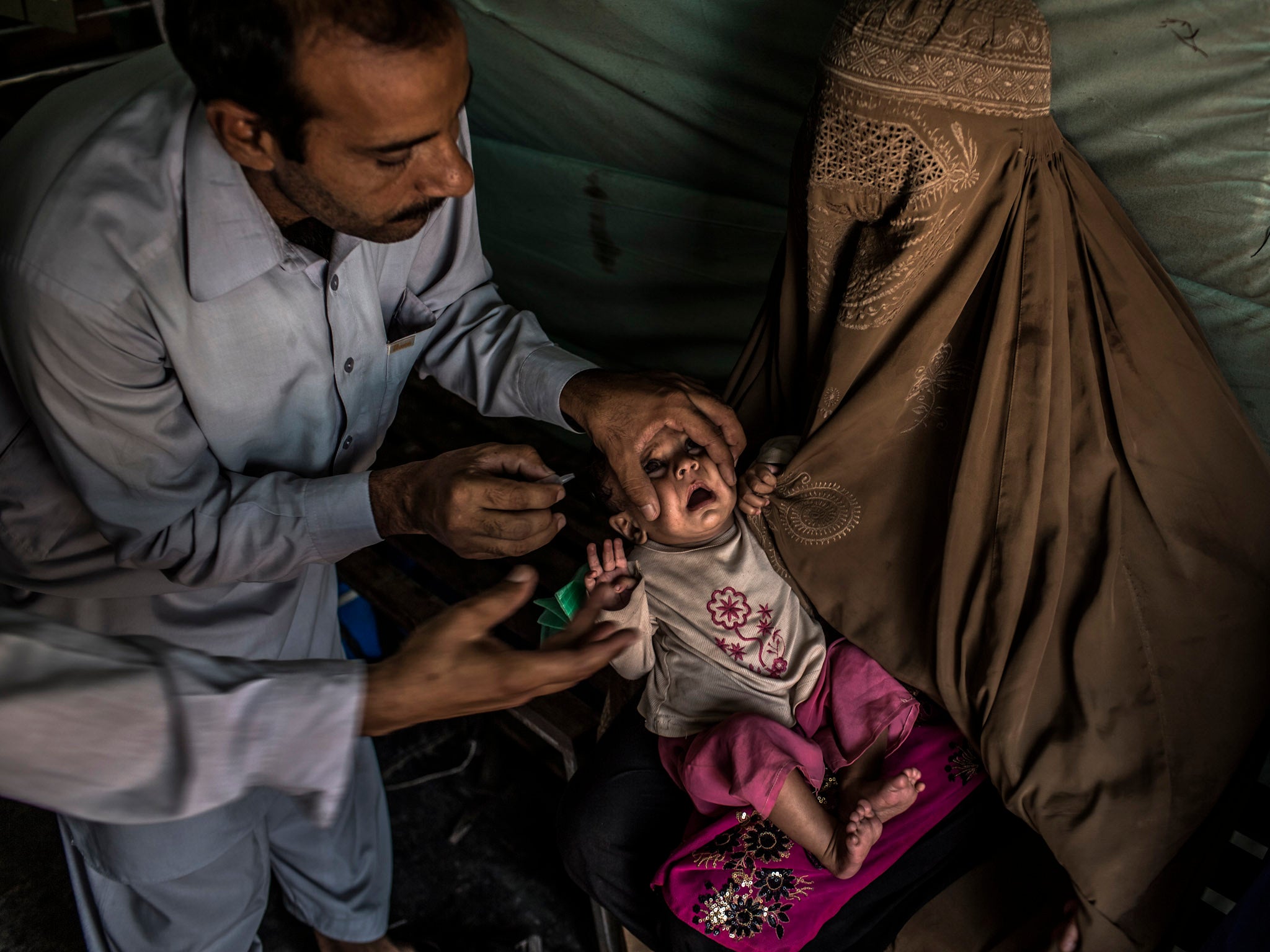 A child in Pakistan is given the polio vaccination