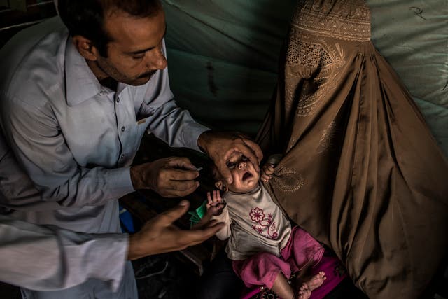 A child in Pakistan is given the polio vaccination