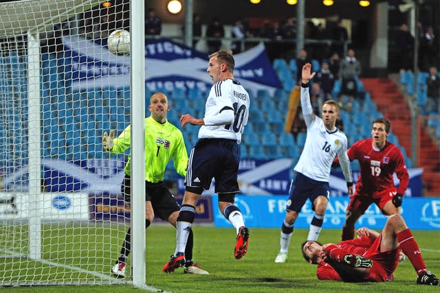 Jordan Rhodes heads in his opening goal for Scotland against Luxembourg