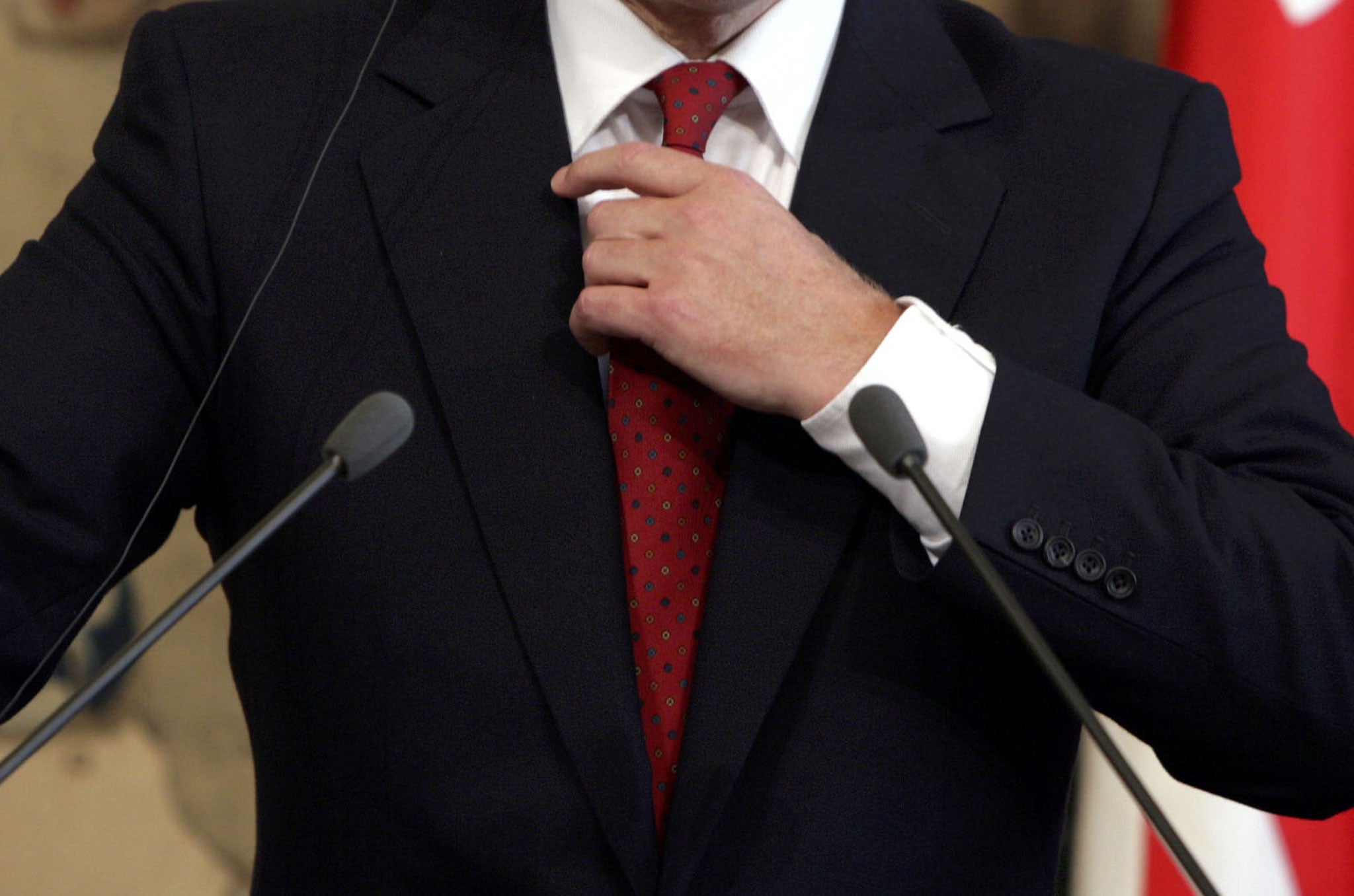 British Prime Minister, Tony Blair adjusts his tie during a press conference with Italian counterpart Silvio Berlusconi at Chigi palace May 27, 2005 in Rome, Italy.