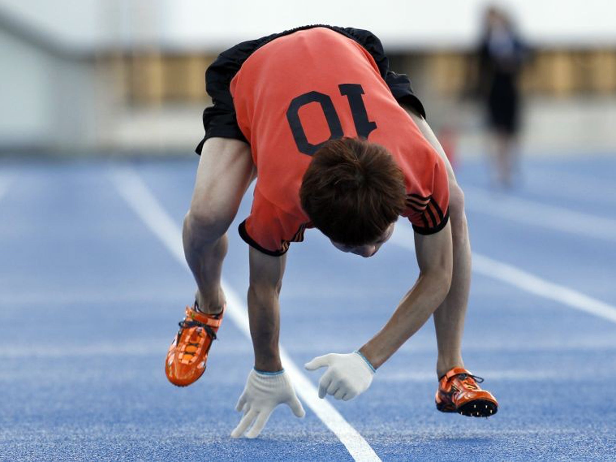 Kenichi Ito runs on a race course on his way to setting the Guinness World Record for the fastest time to run 100 metres on all fours