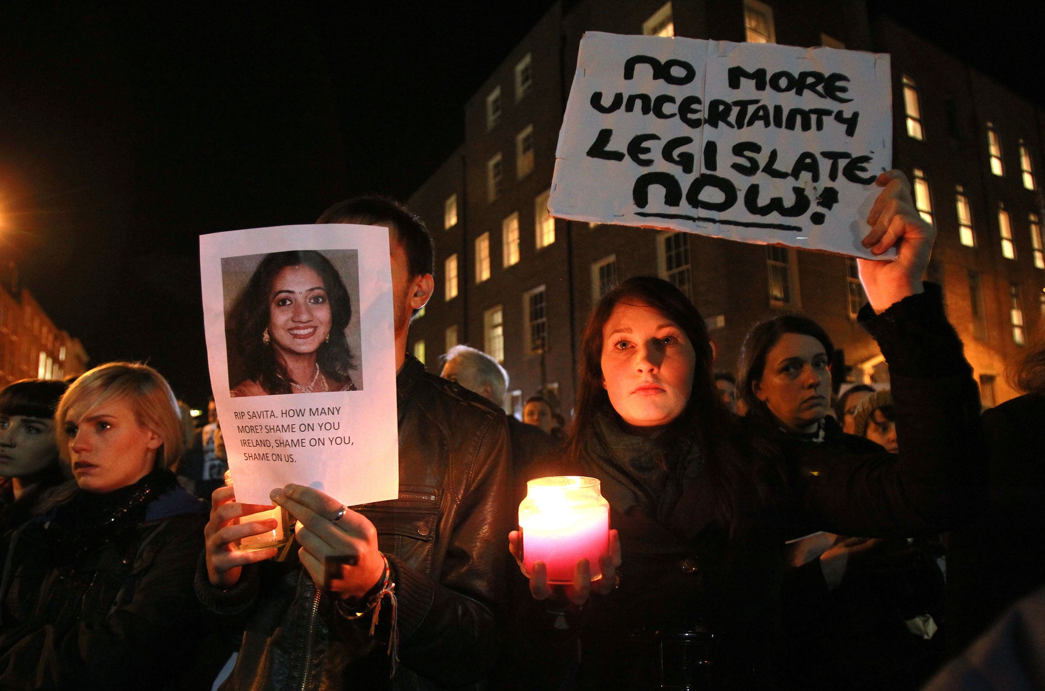 Protestors hold pictures of Savita Halappanavar, who was allegedly refused a pregnancy termination after doctors told her it was a Catholic country, in Dublin, Ireland, on November 14, 2012.