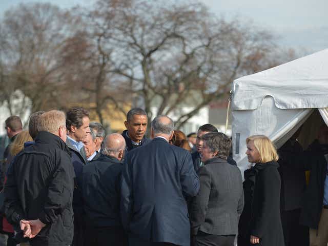 US President Barack Obama talks with New York Governor Andrew Cuomo (2nd L), Senator Chuck Schumer (C, back to camera), D-NY, Homeland Security Secretary Janet Napolitano (2nd R) and Senator Kirsten Gillibrand (R), D-NY, as he visits a FEMA Disaster Recov