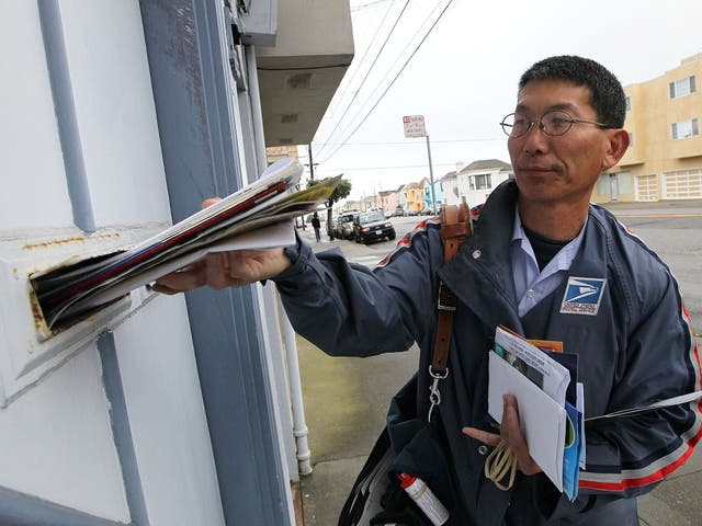US Postal Service lettercarrier Raymond Hou delivers mail along his route 