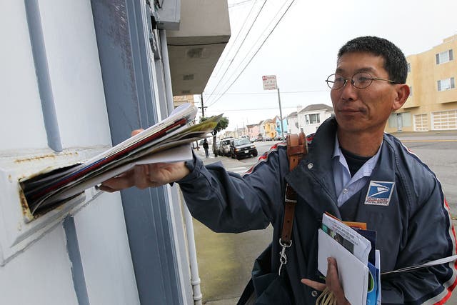 US Postal Service lettercarrier Raymond Hou delivers mail along his route 