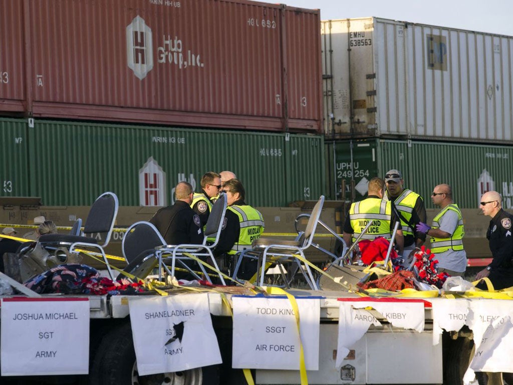 Emergency services at the scene of the accident where a trailer carrying veterans in a parade was struck by a train crossing in Midland, Texas