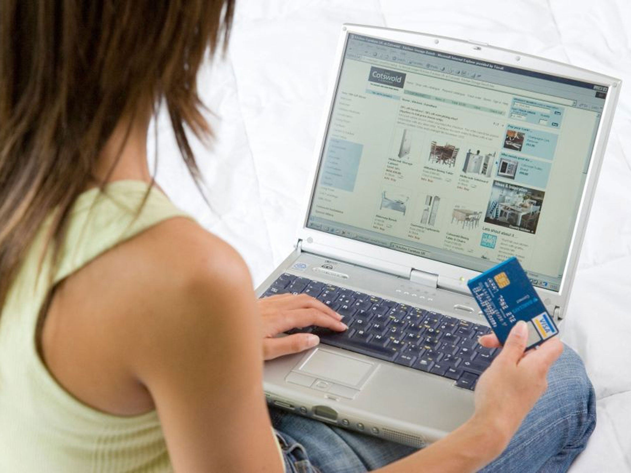 A shopper uses a credit card to buy goods on the internet