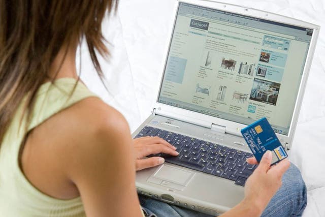 A shopper uses a credit card to buy goods on the internet