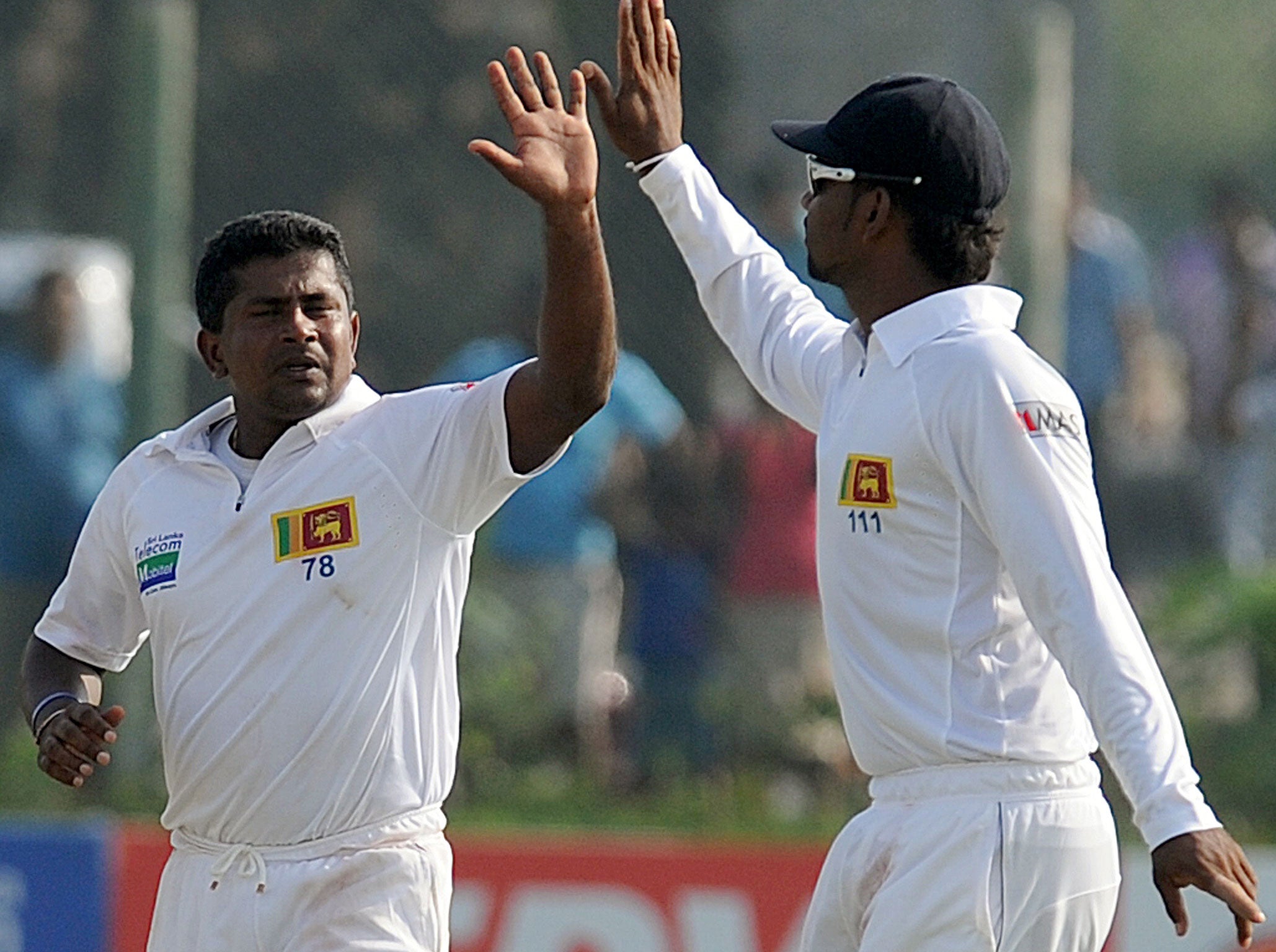 Rangana Herath (left) celebrates the dismissal of New Zealand's Doug Bracewell