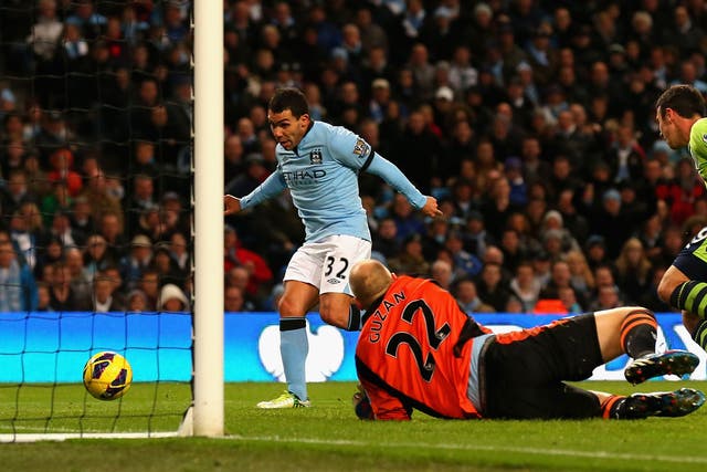 Carlos Tevez slots his second goal past Aston Villa keeper Brad Guzan