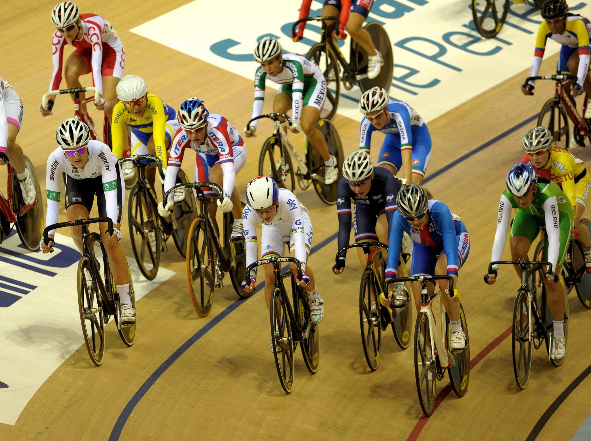 Golden girl: Laura Trott (centre, in white) competes in the omnium at the Track World Cup in Glasgow yesterday