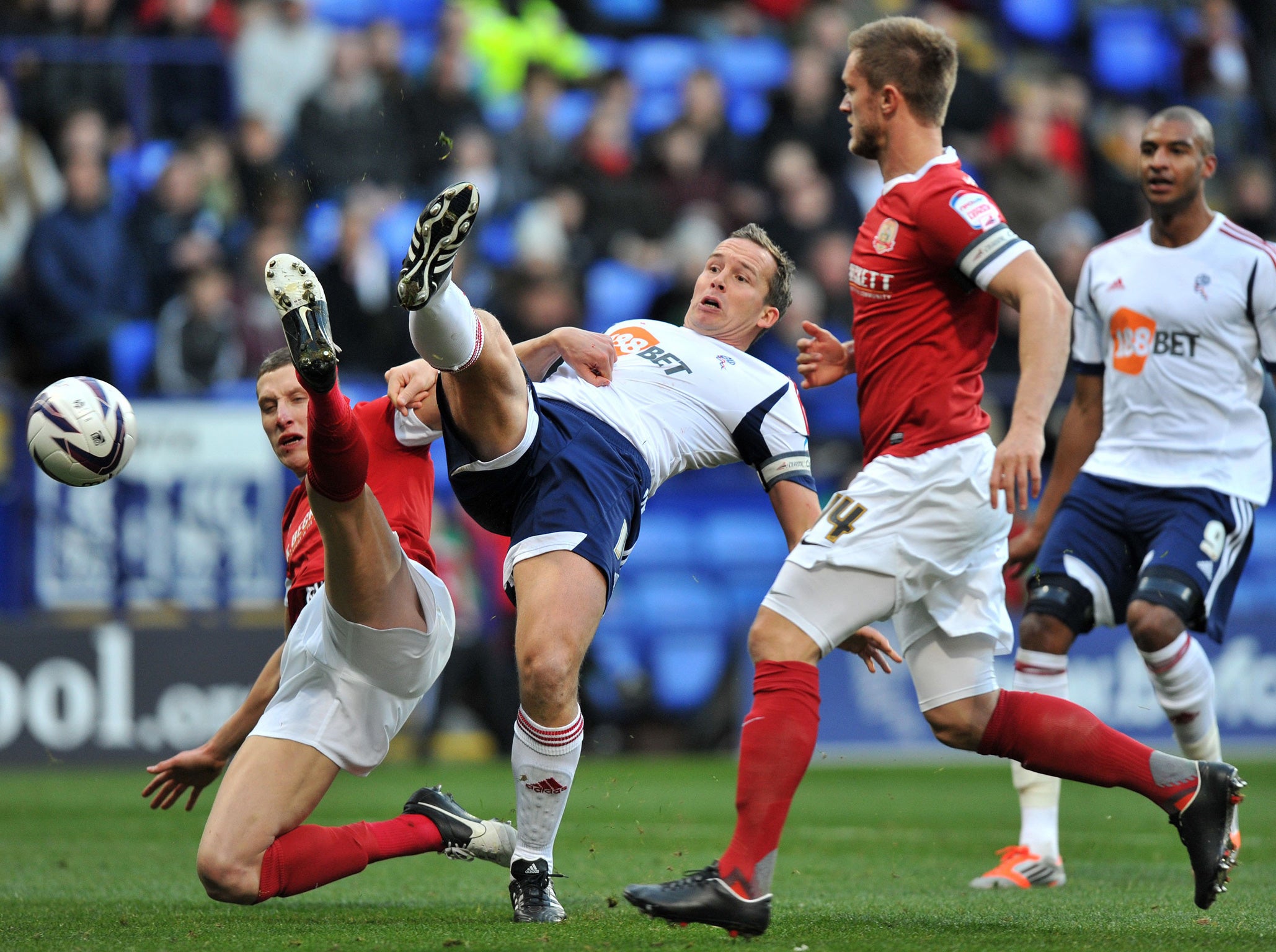Leg up: Bolton’s Kevin Davies challenges Barnsley’s Jim McNulty for the ball