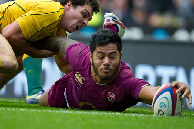 Manu Tuilagi inches the ball over the line for England’s one try against Australia yesterday