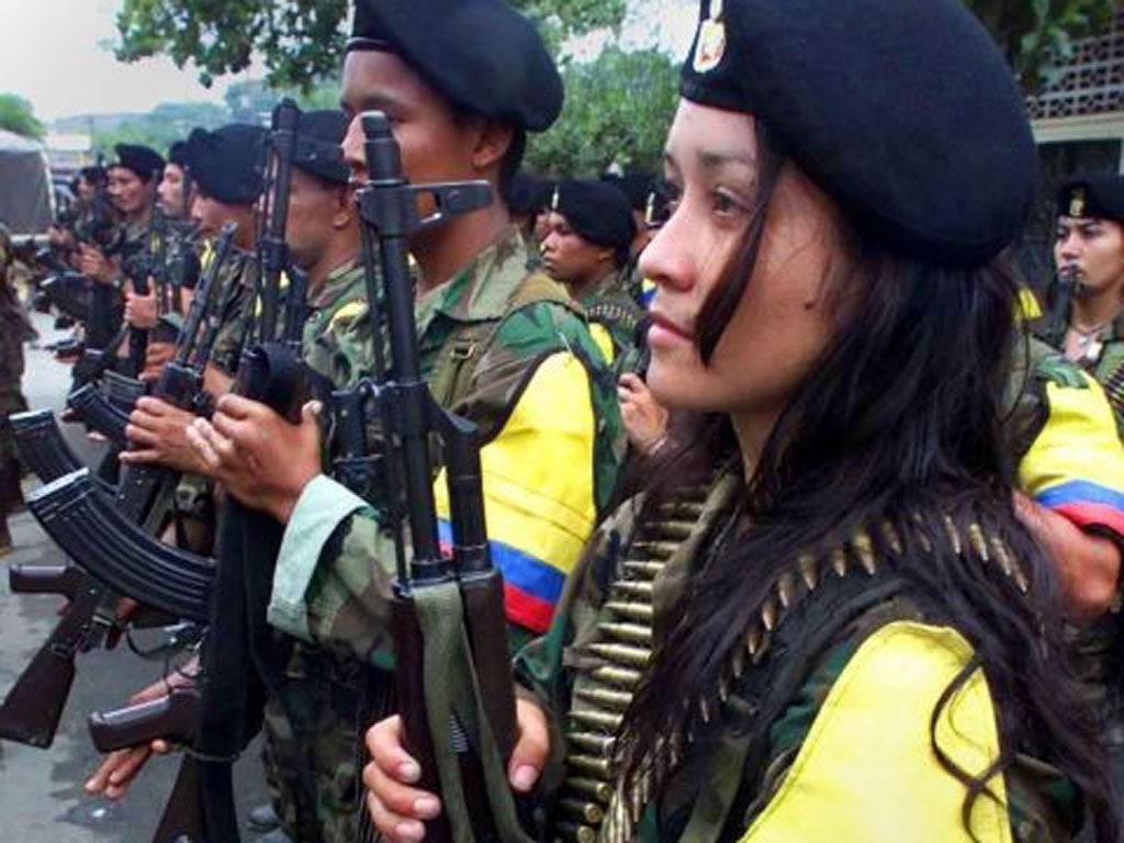 Farc soldiers parade in the town of San Vicente del Caguan (AP)