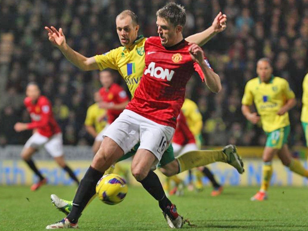Michael Carrick tussles with Norwich’s Steven Whittaker as Manchester United suffer their third Premier League defeat of the season on Saturday