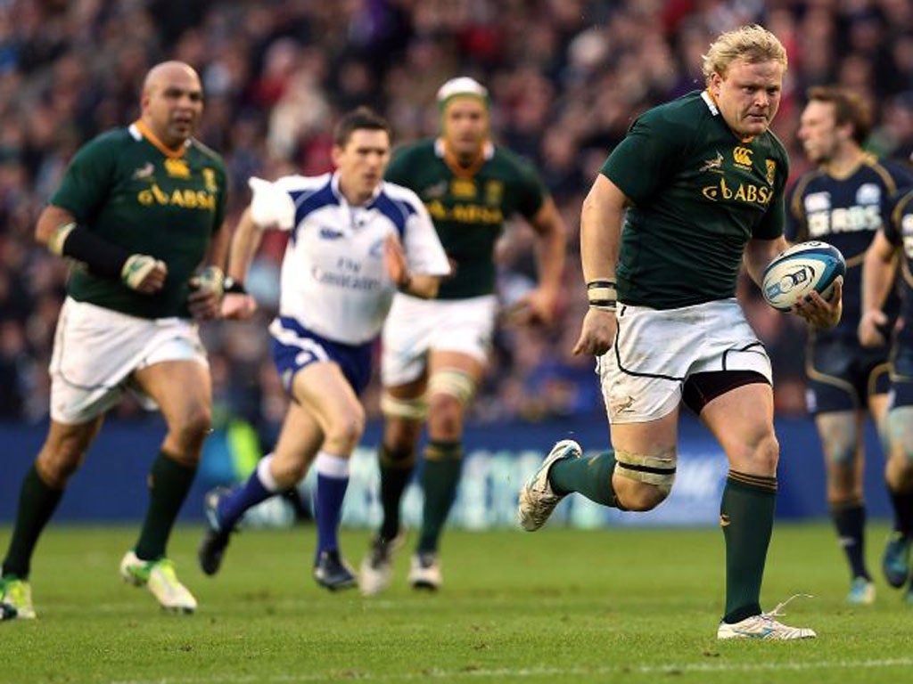 Adriaan Strauss breaks clear to score his second try against Scotland at Murrayfield on Saturday