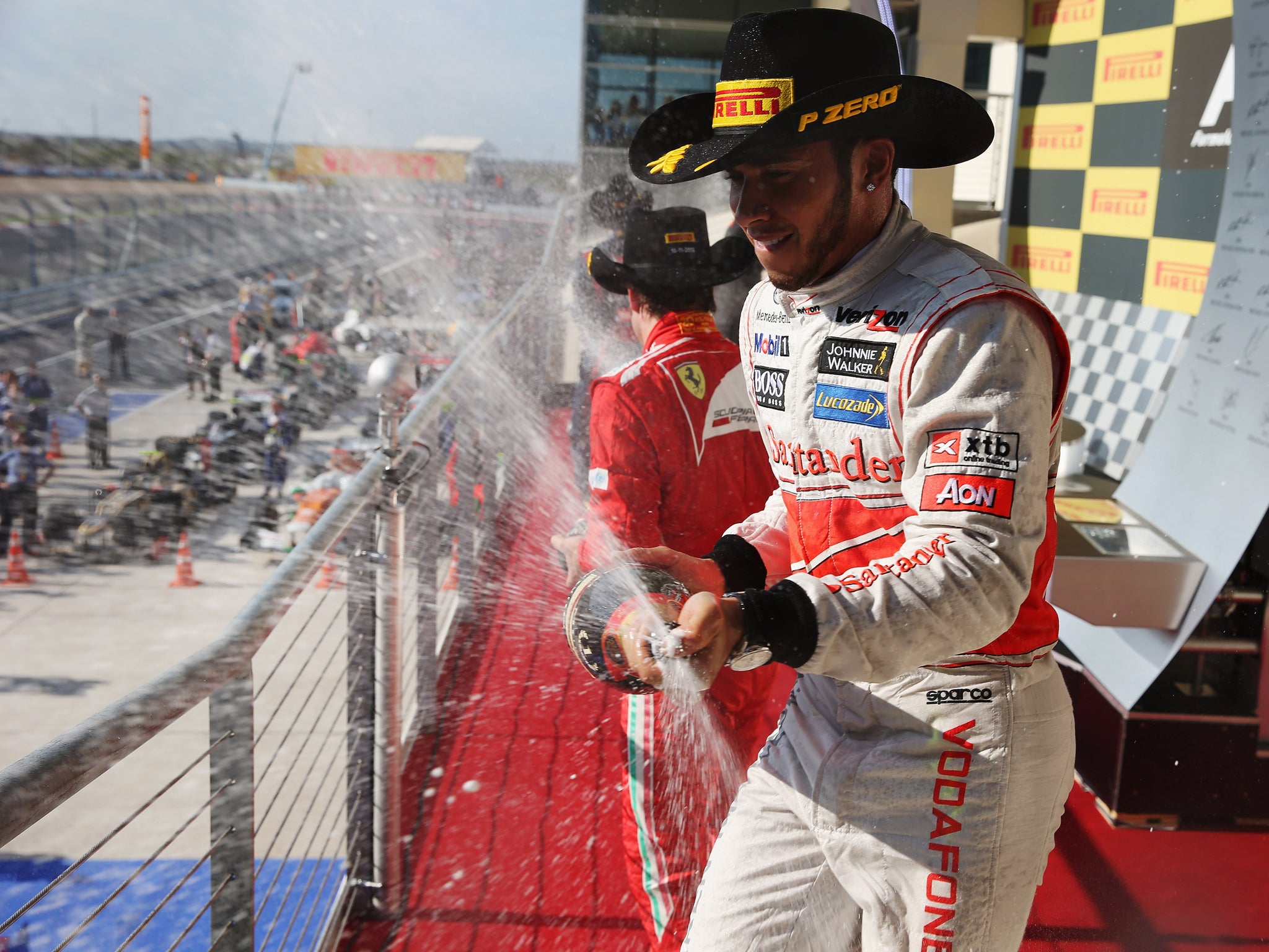 Lewis Hamilton celebrates on the podium after winning the United States Formula One Grand Prix