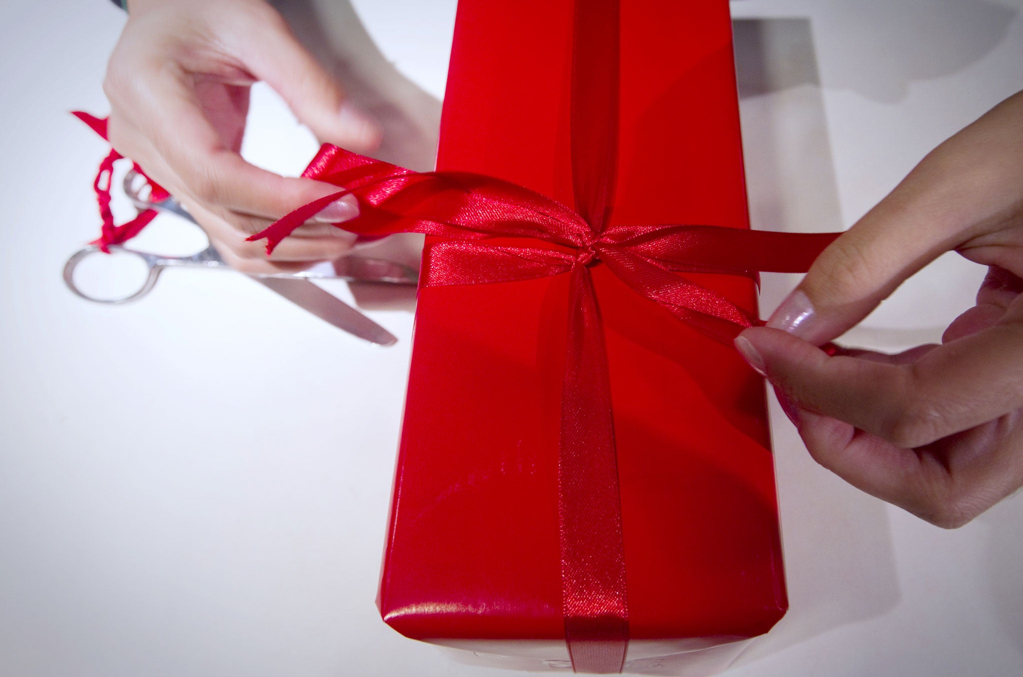 A seller wraps a gift in a Parisian department store on December 15, 2011, one week ahead of Christmas feast.